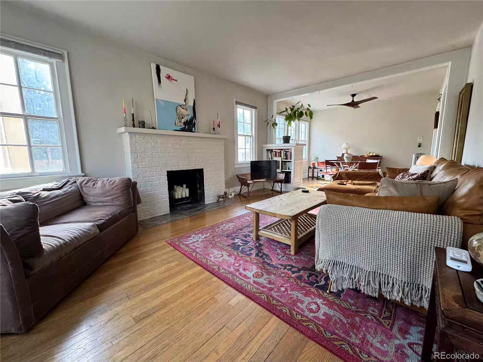 966 Garfield Street Denver, CO 80206 - Photo 2 of 27 a living room with furniture and a fireplace