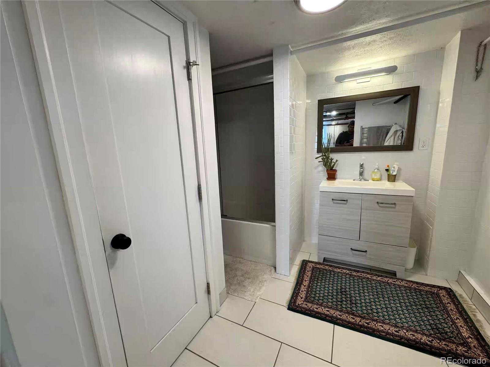 966 Garfield Street Denver, CO 80206 - Photo 23 of 27 a bathroom with a sink a toilet and shower