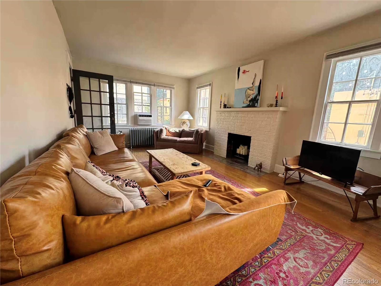 966 Garfield Street Denver, CO 80206 - Photo 4 of 27 a living room with furniture fireplace and window