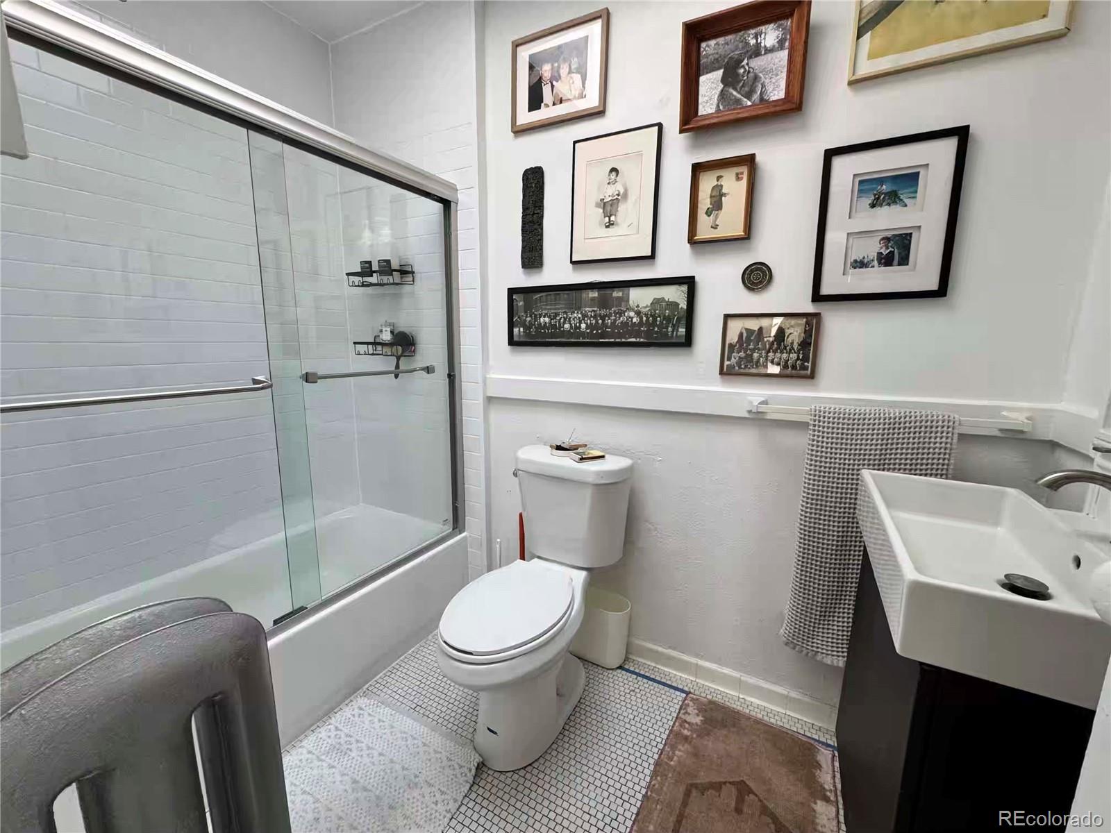 966 Garfield Street Denver, CO 80206 - Photo 10 of 27 a white toilet sitting next to a bathroom sink