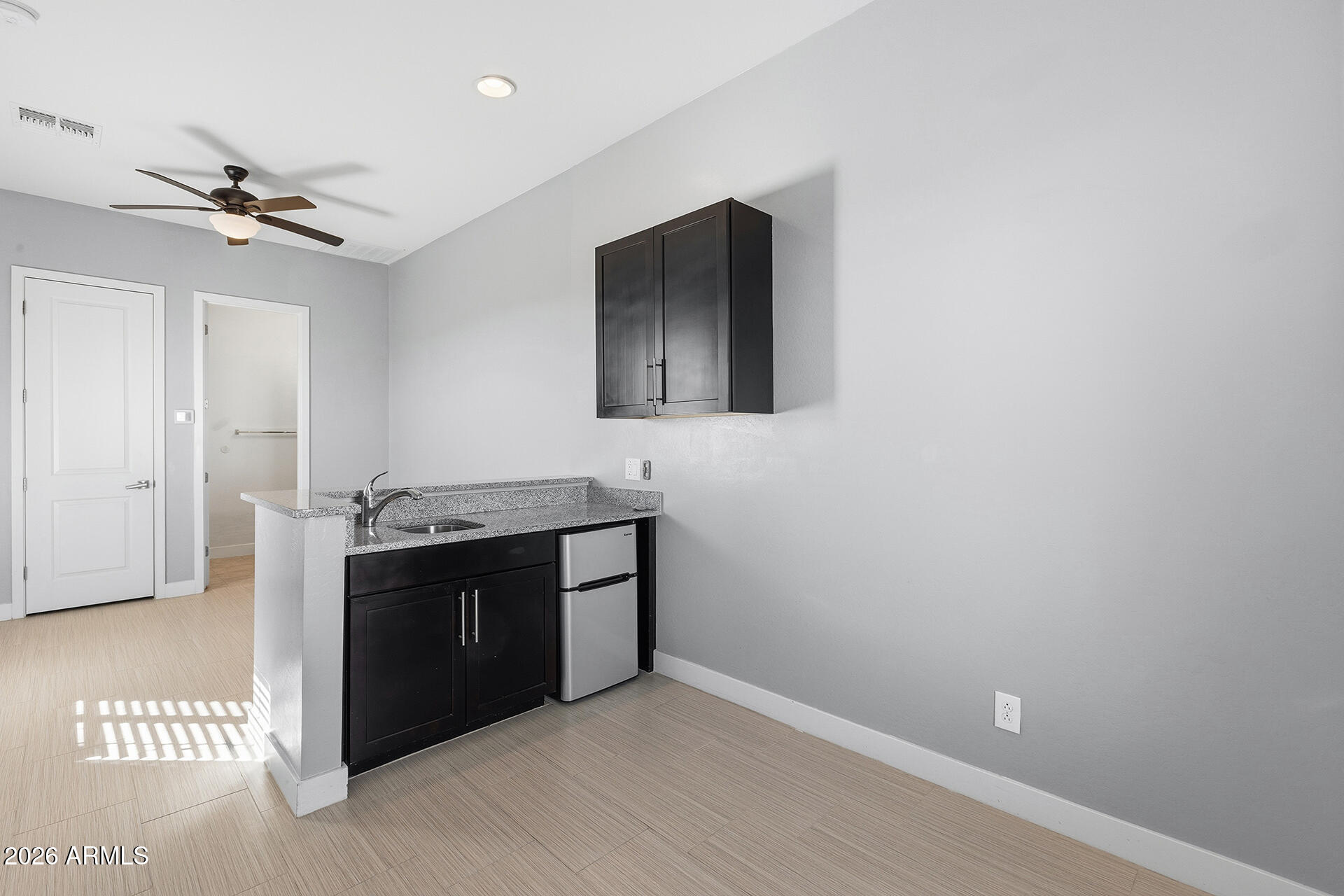 12035 West Roy Rogers Road Peoria, AZ 85383 - Photo 11 of 46 a view of kitchen with stainless steel appliances cabinets and a ceiling fan