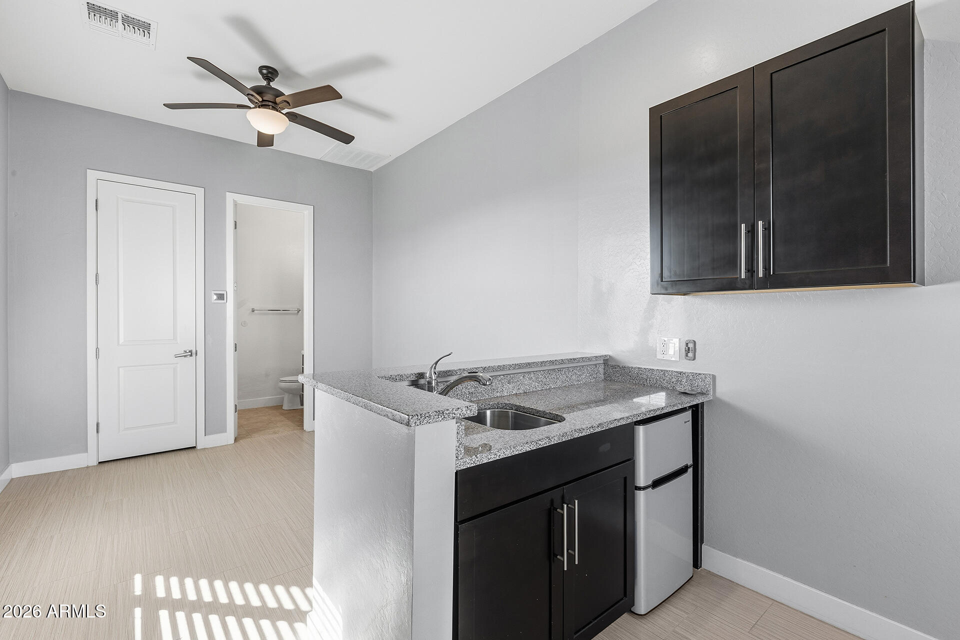 12035 West Roy Rogers Road Peoria, AZ 85383 - Photo 13 of 46 a kitchen with a stove and a microwave