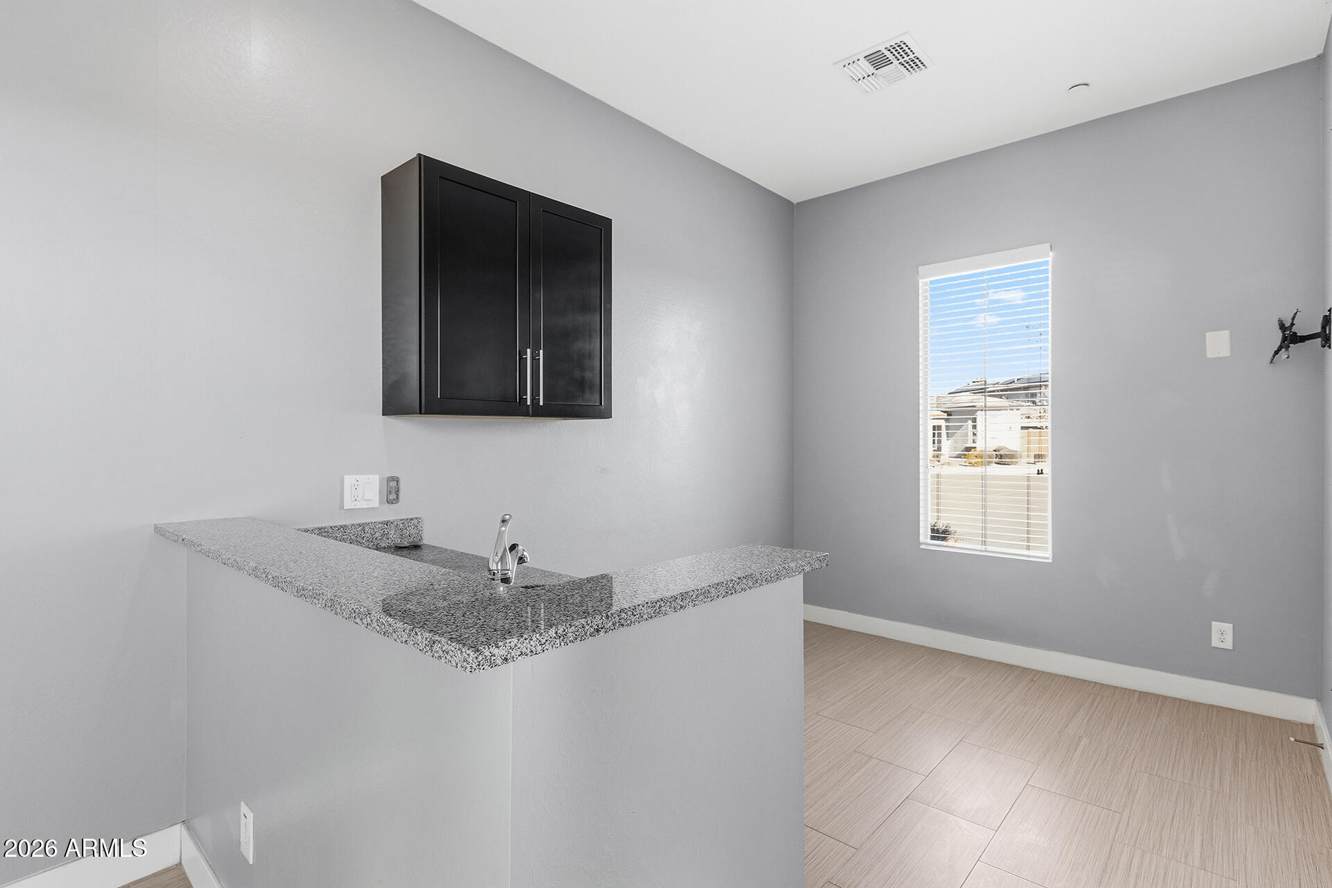 12035 West Roy Rogers Road Peoria, AZ 85383 - Photo 14 of 46 a bathroom with a granite countertop sink a mirror and a window