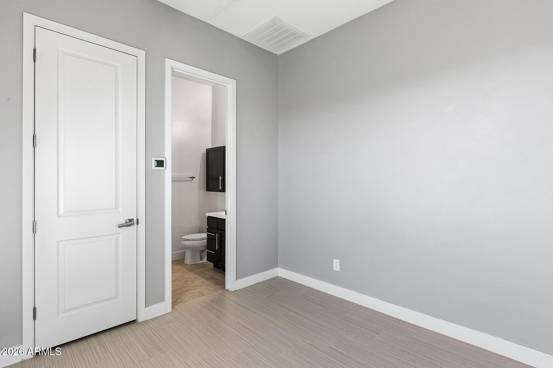 12035 West Roy Rogers Road Peoria, AZ 85383 - Photo 15 of 46 an empty room with closet and wooden door