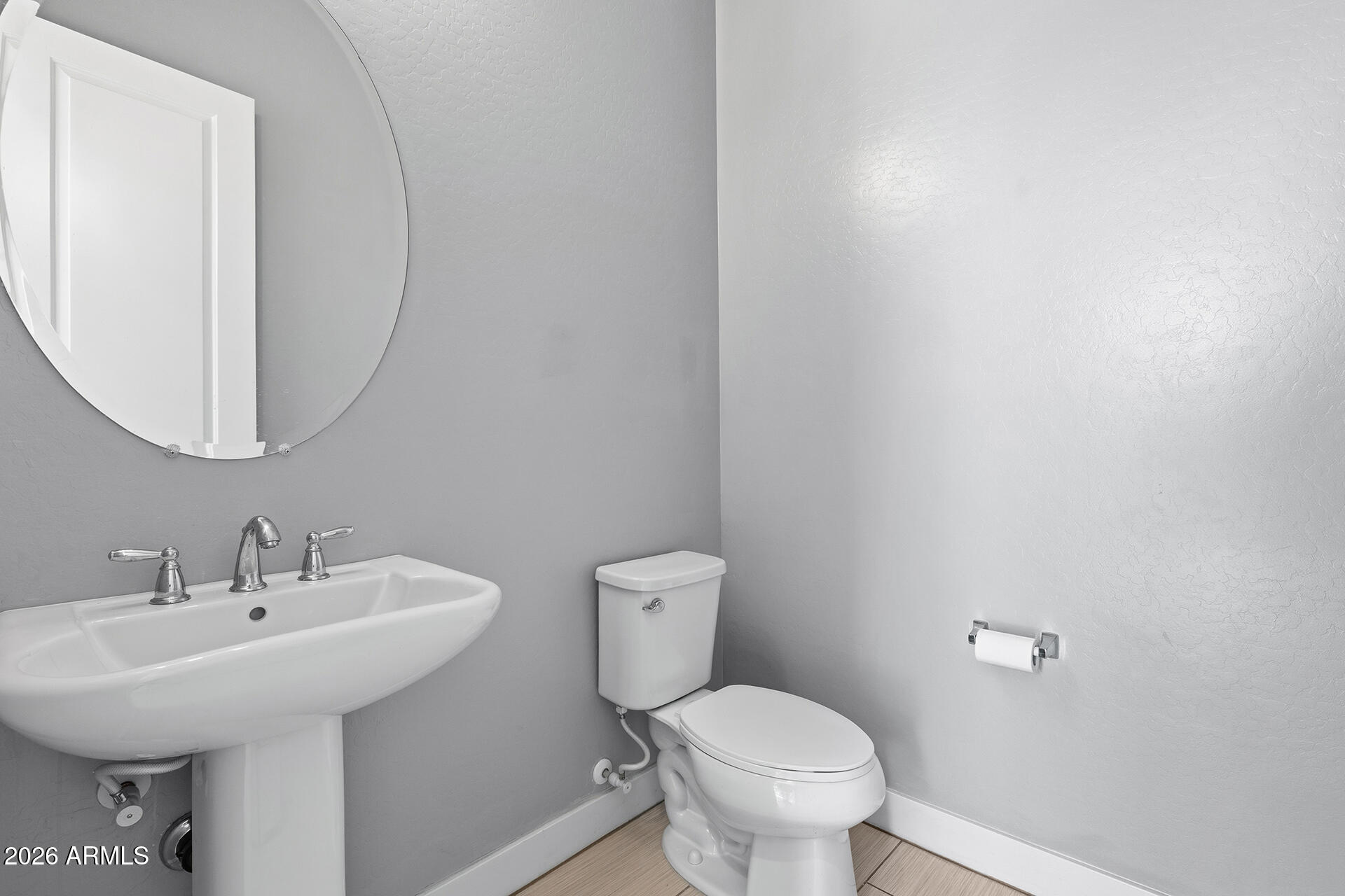 12035 West Roy Rogers Road Peoria, AZ 85383 - Photo 19 of 46 a bathroom with a toilet sink and mirror