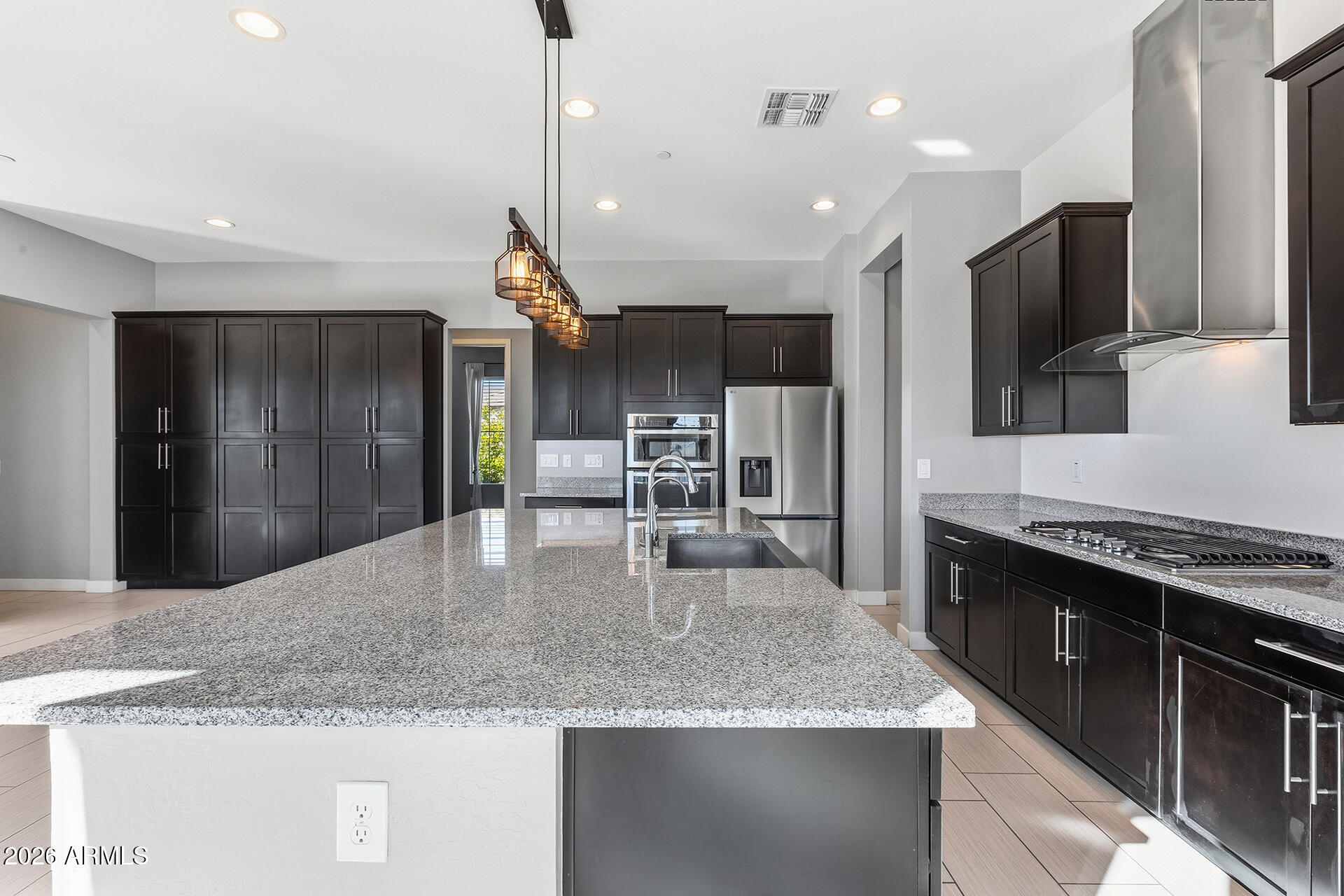 12035 West Roy Rogers Road Peoria, AZ 85383 - Photo 20 of 46 a kitchen with stainless steel appliances granite countertop a sink a stove and a refrigerator