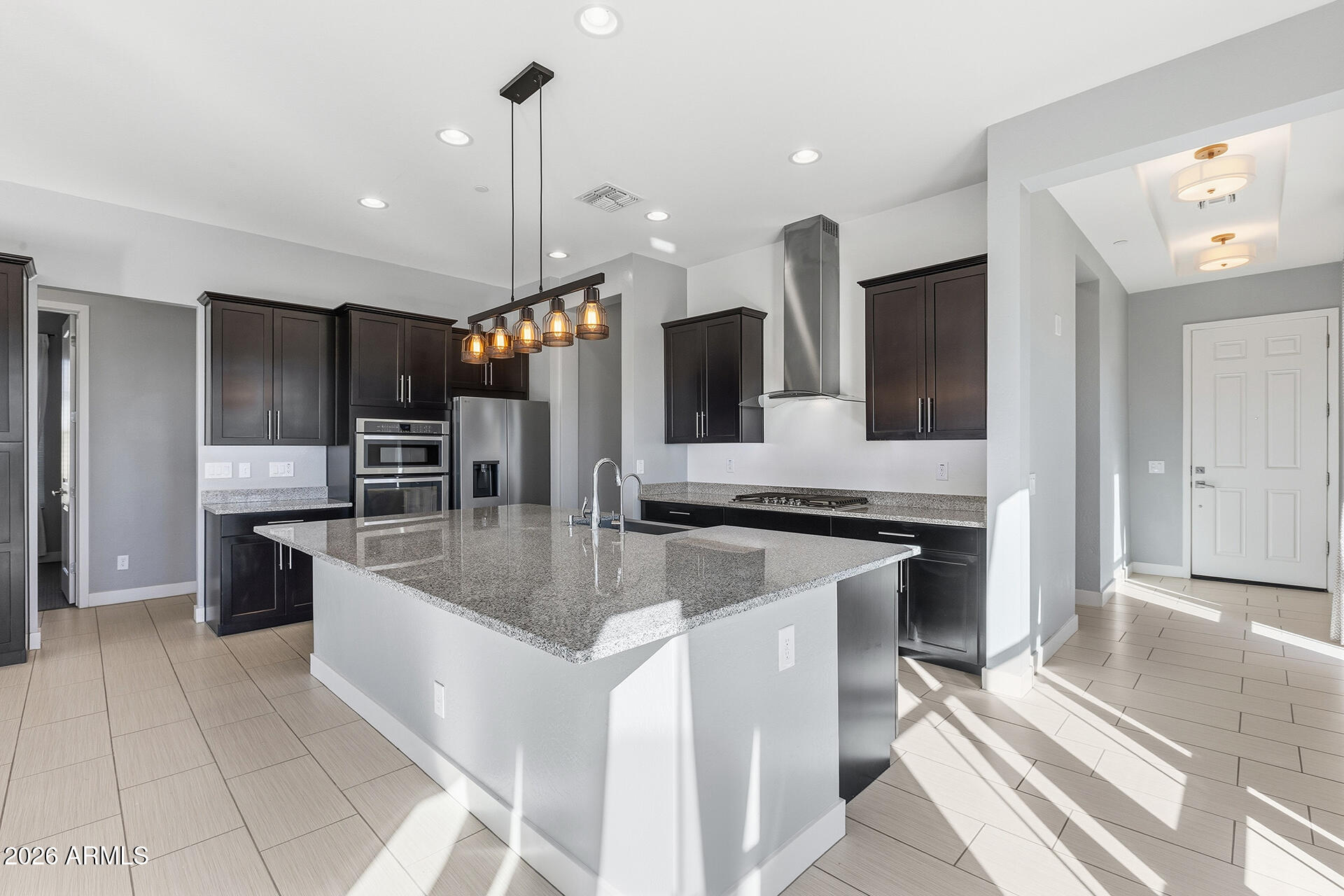 12035 West Roy Rogers Road Peoria, AZ 85383 - Photo 21 of 46 a kitchen with stainless steel appliances granite countertop a sink and a stove