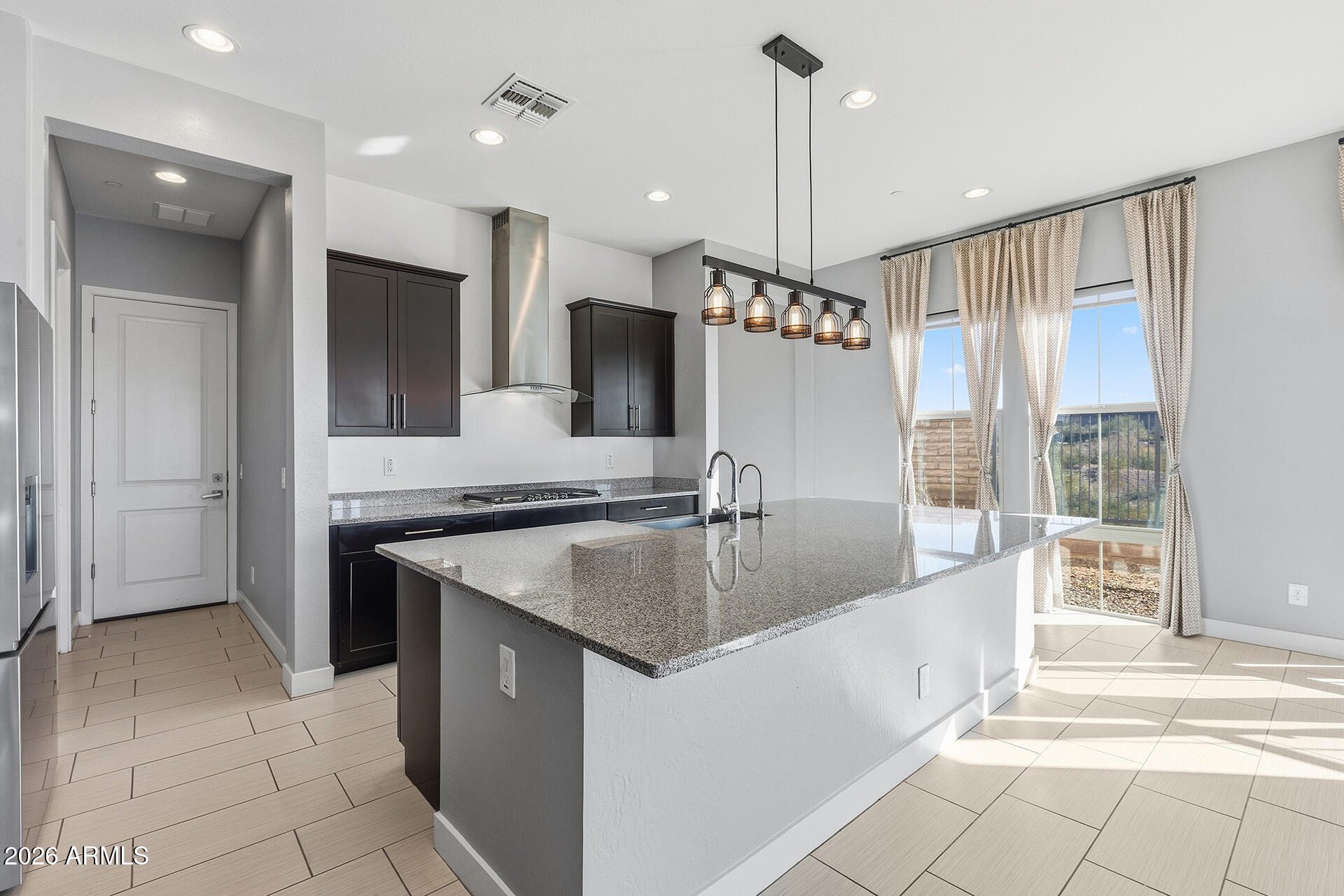 12035 West Roy Rogers Road Peoria, AZ 85383 - Photo 23 of 46 a kitchen with stainless steel appliances granite countertop a sink and a refrigerator