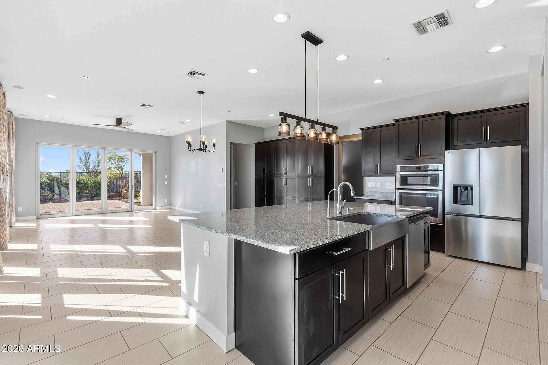 12035 West Roy Rogers Road Peoria, AZ 85383 - Photo 2 of 46 a kitchen with kitchen island granite countertop a sink and refrigerator