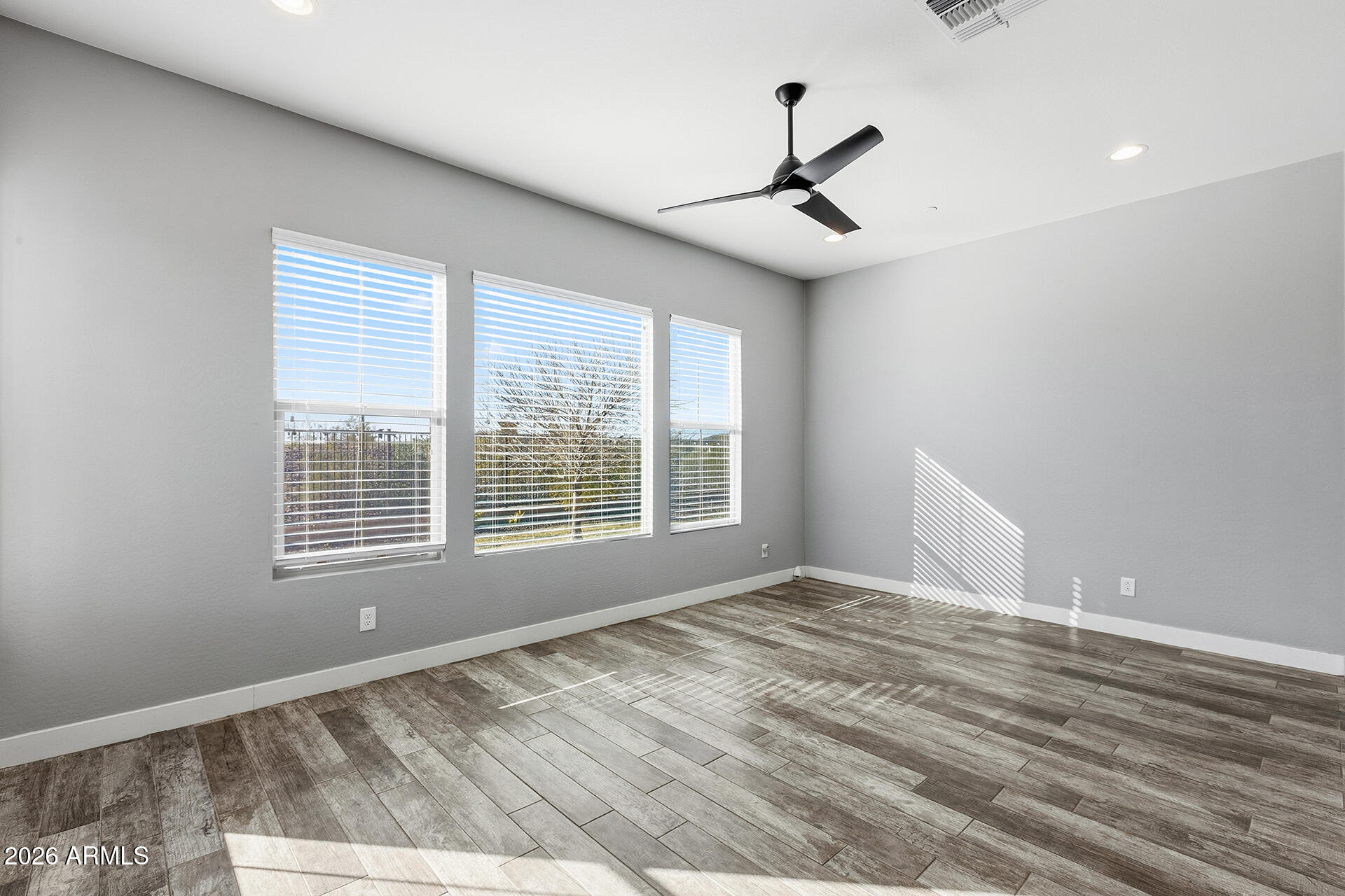 12035 West Roy Rogers Road Peoria, AZ 85383 - Photo 35 of 46 a view of an empty room with a window and wooden floor