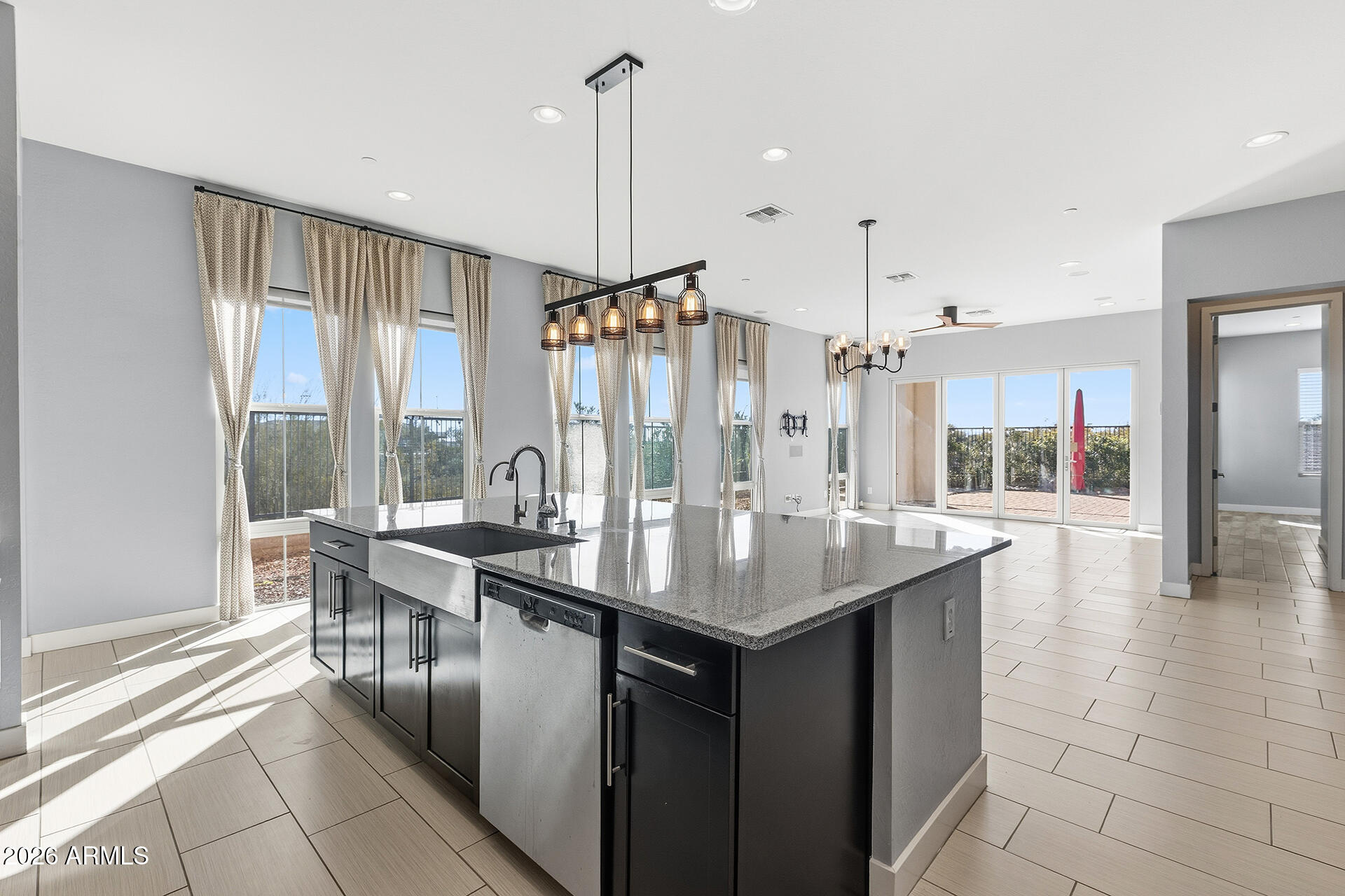 12035 West Roy Rogers Road Peoria, AZ 85383 - Photo 3 of 46 a kitchen with stainless steel appliances granite countertop a sink and a counter space