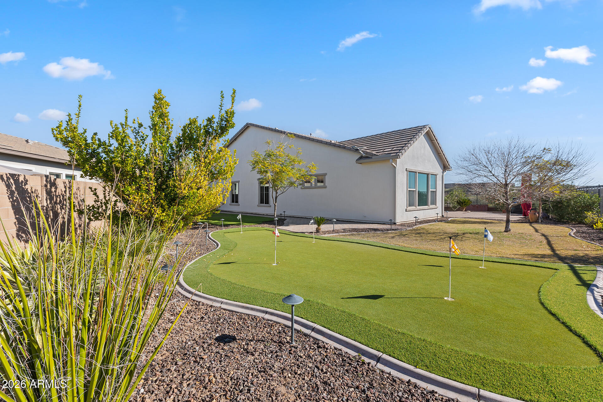 12035 West Roy Rogers Road Peoria, AZ 85383 - Photo 6 of 46 a view of a swimming pool with a lawn chairs and potted plants