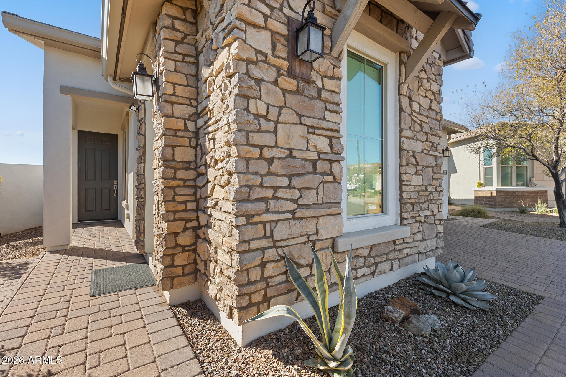 12035 West Roy Rogers Road Peoria, AZ 85383 - Photo 8 of 46 a view of a brick house with a door