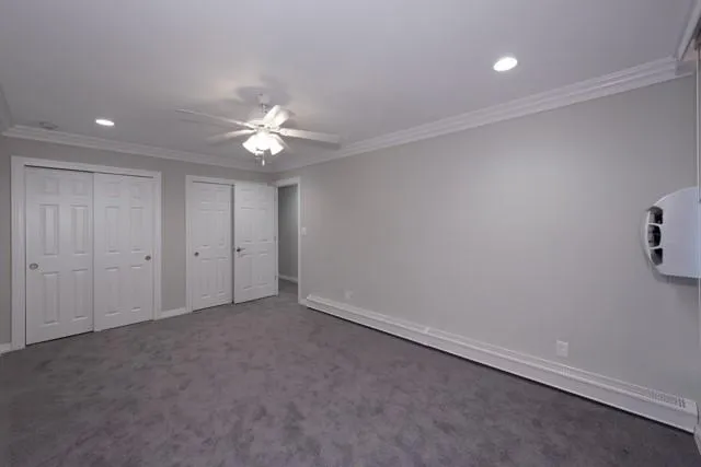 an empty room with a fan and a ceiling fan