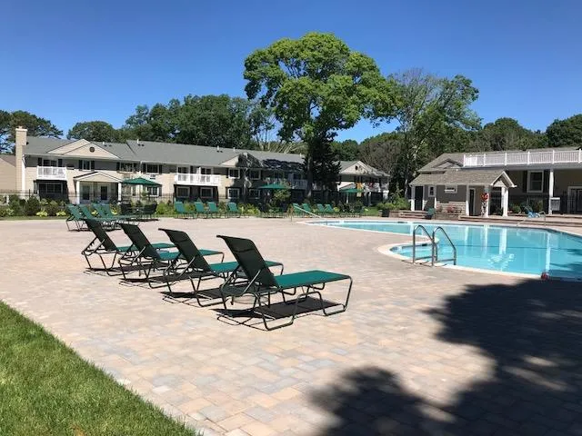a view of a house with sitting area and garden
