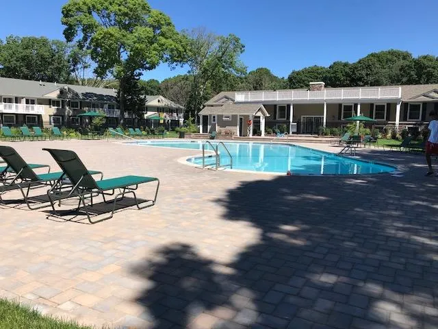 a view of a house with backyard porch and sitting area