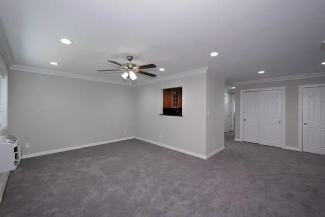 a view of an empty room with a fan