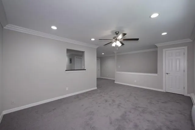 a view of an empty room with a ceiling fan