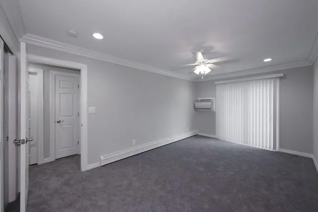 a view of an empty room with a ceiling fan