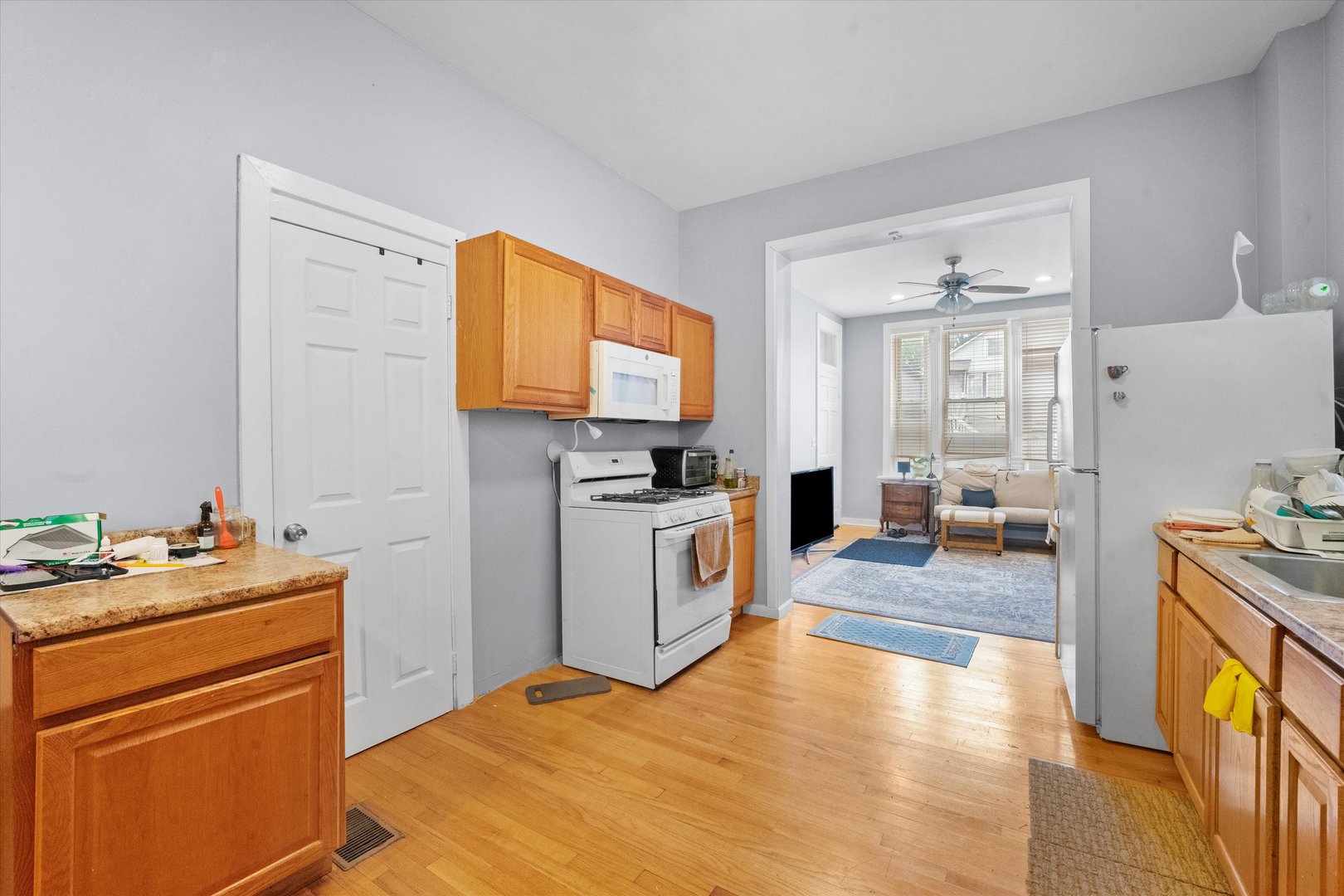 2129 West 18th Place Chicago, IL 60608 - Photo 17 of 38 a kitchen with a stove a sink and a refrigerator