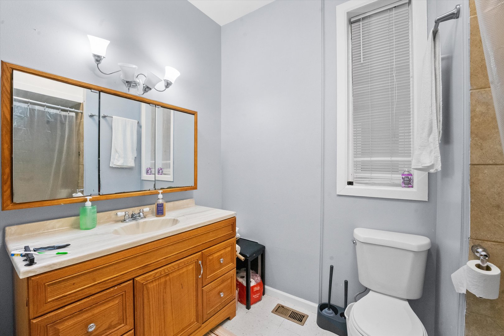 2129 West 18th Place Chicago, IL 60608 - Photo 21 of 38 a bathroom with a sink vanity mirror and toilet