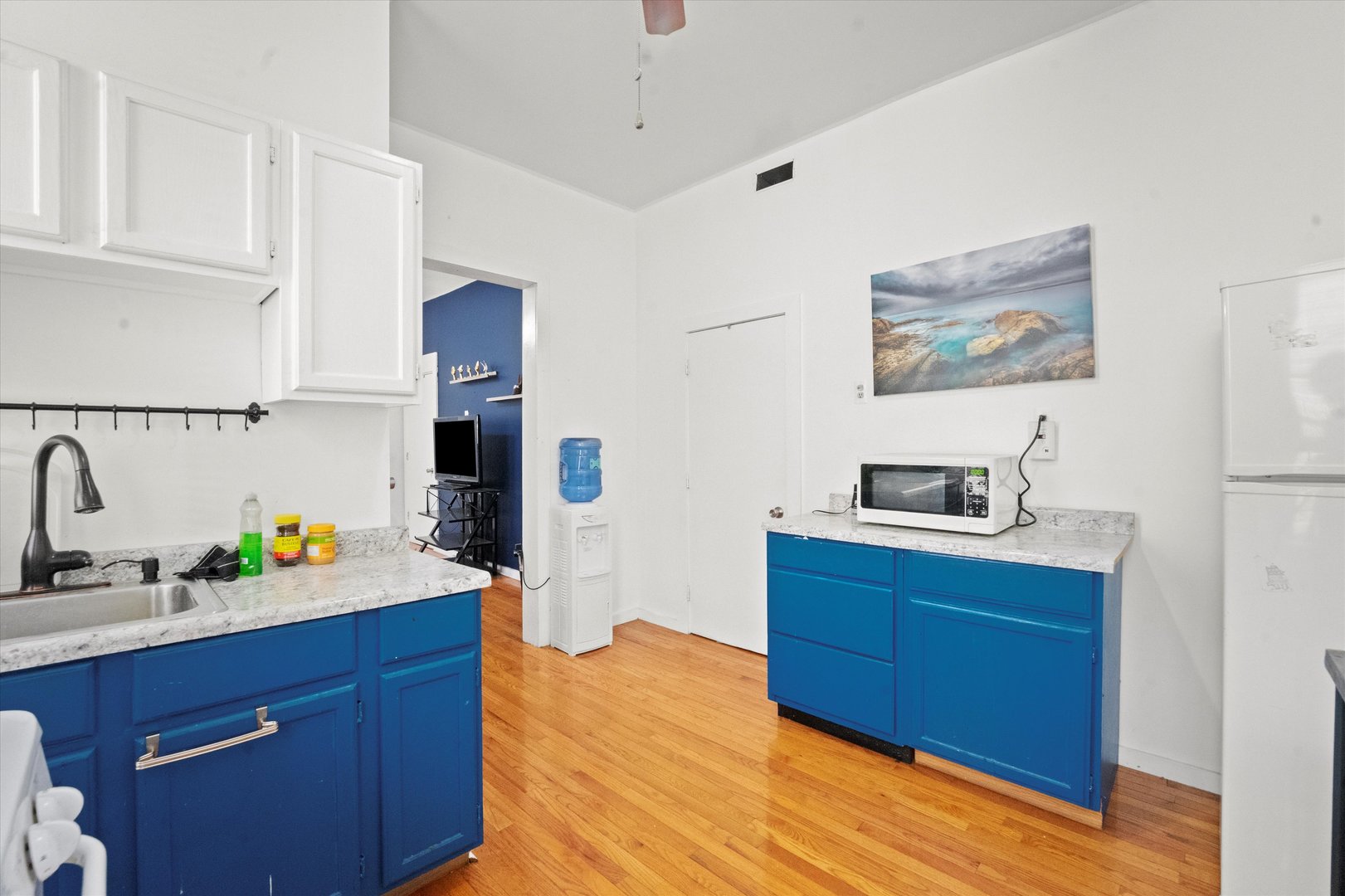2129 West 18th Place Chicago, IL 60608 - Photo 24 of 38 a kitchen with stainless steel appliances a sink cabinets and wooden floor