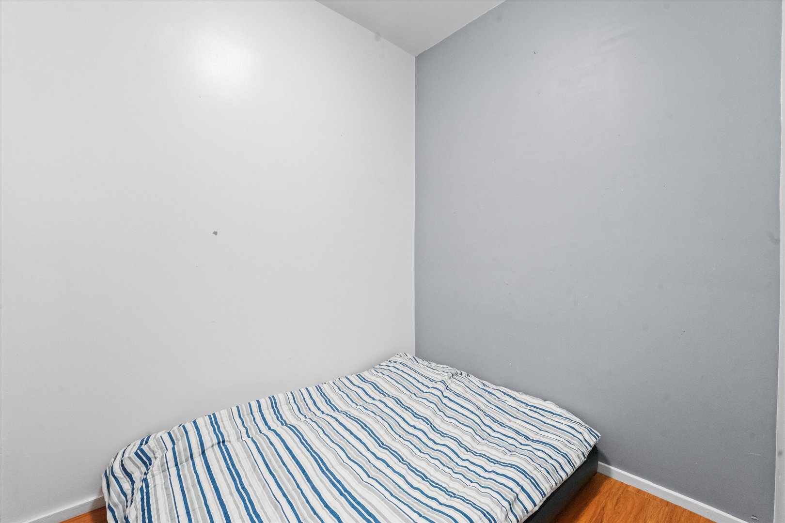 2129 West 18th Place Chicago, IL 60608 - Photo 28 of 38 a view of a bedroom with wooden floor
