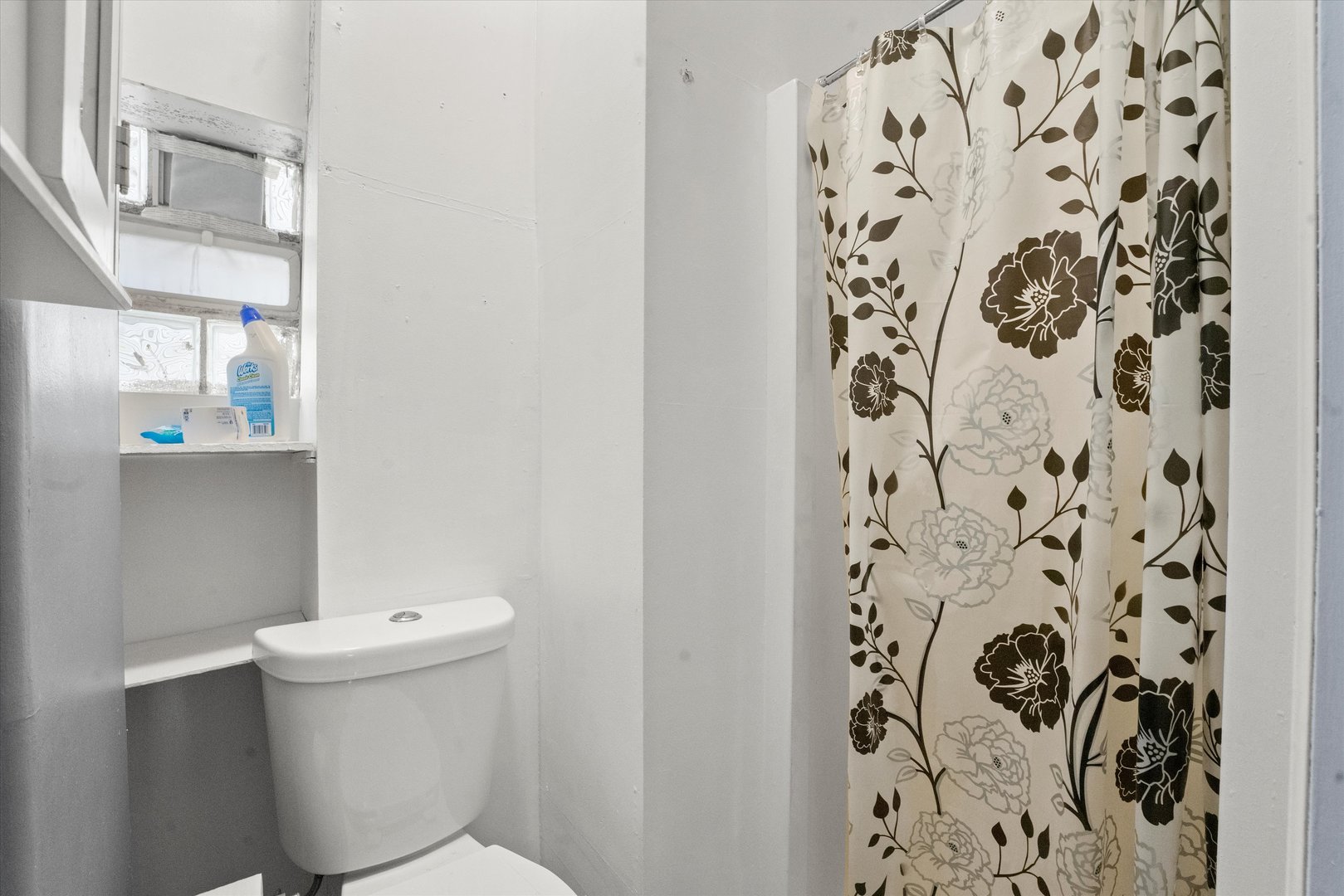 2129 West 18th Place Chicago, IL 60608 - Photo 29 of 38 a white toilet sitting next to a shower curtain