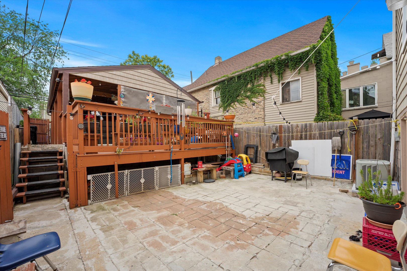 2129 West 18th Place Chicago, IL 60608 - Photo 31 of 38 a view of a house with a patio and a yard