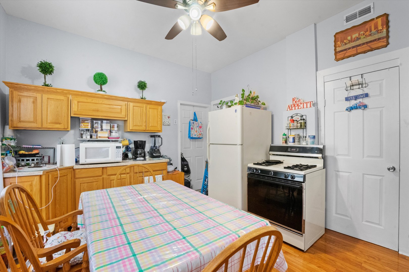2129 West 18th Place Chicago, IL 60608 - Photo 6 of 38 a kitchen with a refrigerator and a stove top oven