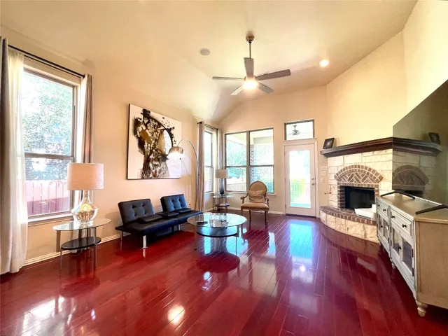 a living room with furniture a fireplace and a flat screen tv