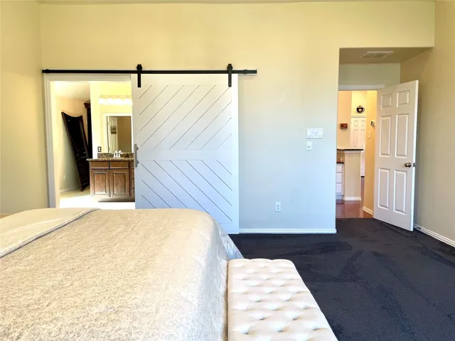 a view of a bedroom with wooden floor