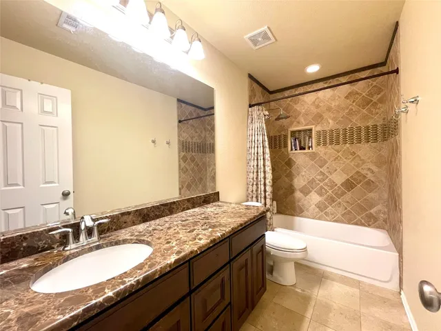 a view of a living room kitchen with furniture and a wooden floor