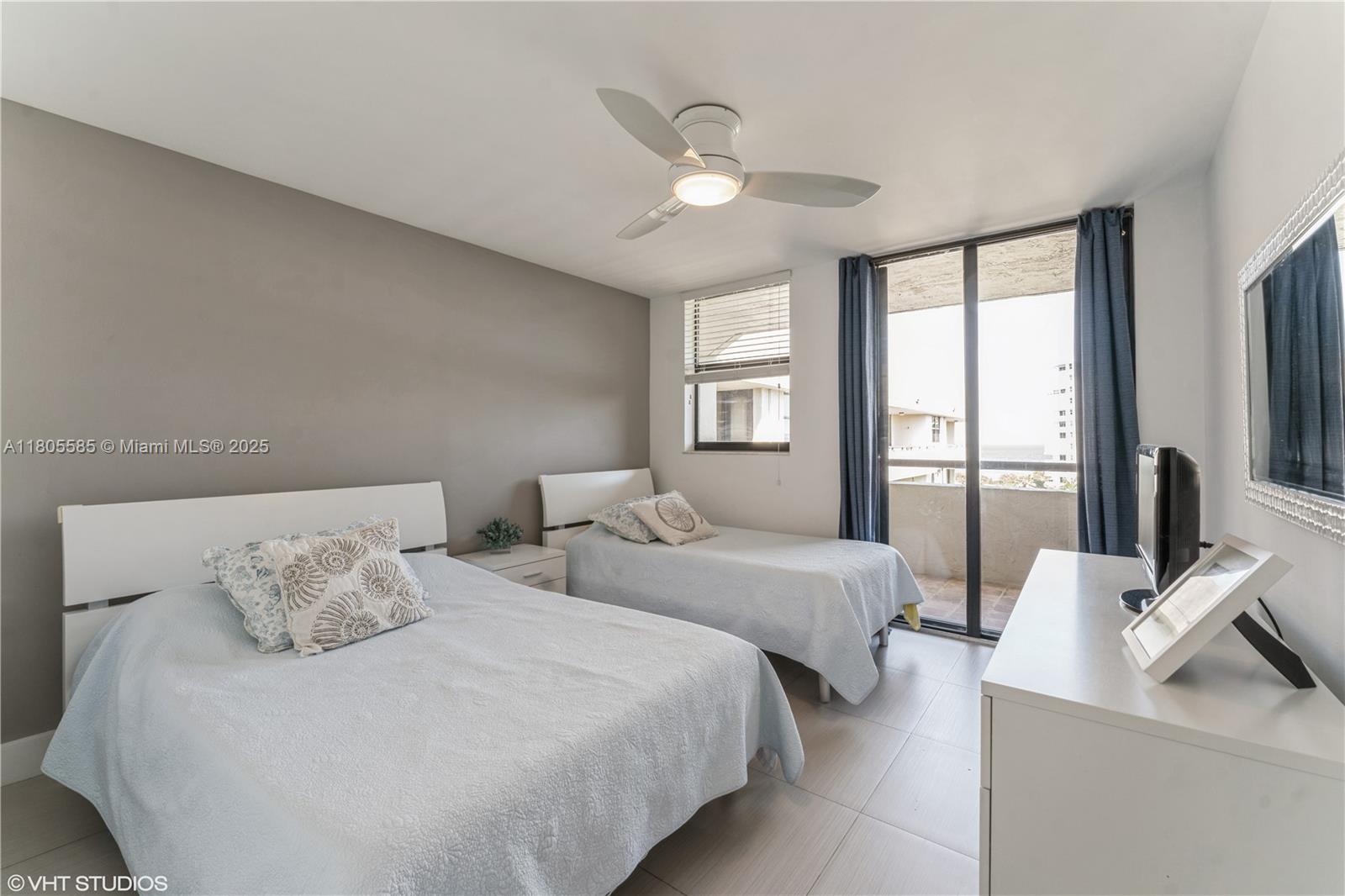 170 Ocean Ln Drive, Unit 906 Key Biscayne, FL 33149 - Photo 18 of 26 a bedroom with two beds and a large window