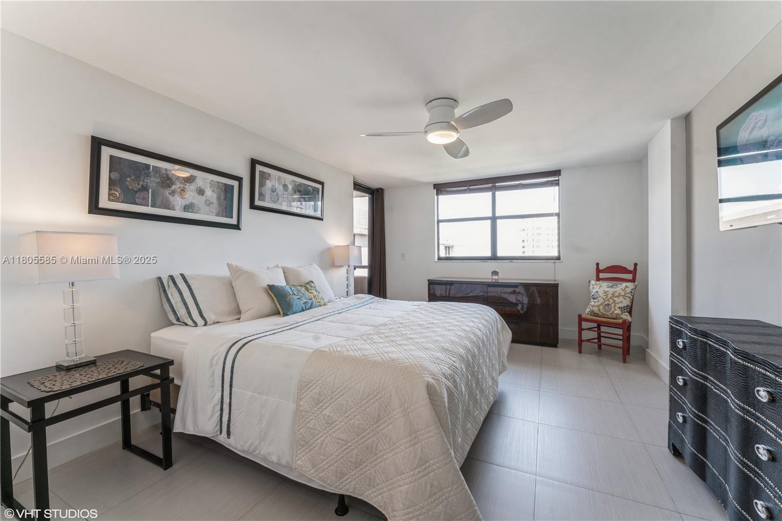 170 Ocean Ln Drive, Unit 906 Key Biscayne, FL 33149 - Photo 19 of 26 a spacious bedroom with a bed a dresser and a window
