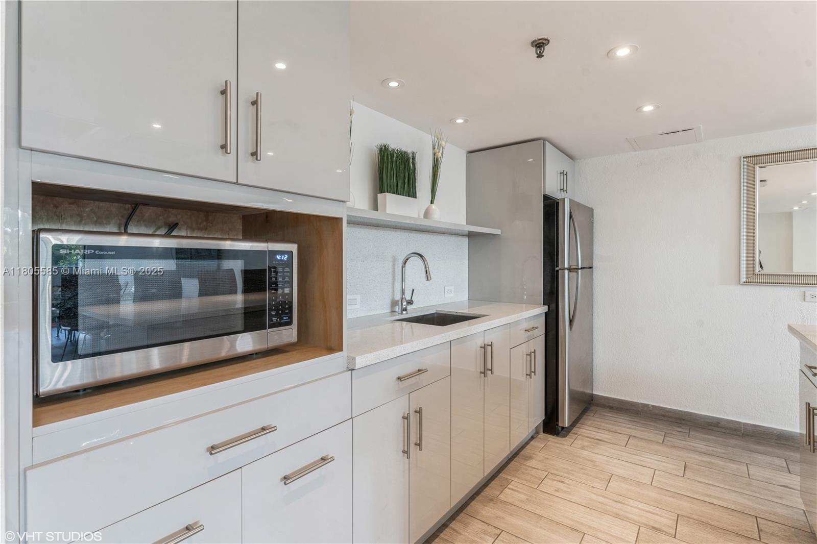 170 Ocean Ln Drive, Unit 906 Key Biscayne, FL 33149 - Photo 25 of 26 a kitchen with stainless steel appliances granite countertop white cabinets a refrigerator and a stove top oven