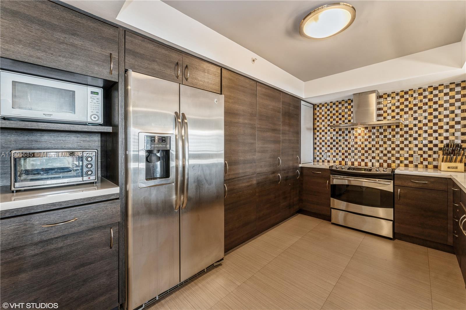 170 Ocean Ln Drive, Unit 906 Key Biscayne, FL 33149 - Photo 5 of 26 a kitchen with a refrigerator and a stove