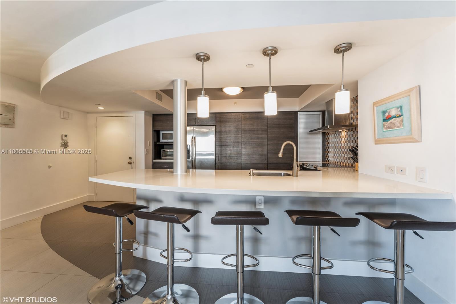 170 Ocean Ln Drive, Unit 906 Key Biscayne, FL 33149 - Photo 6 of 26 a kitchen with a table and chairs in it