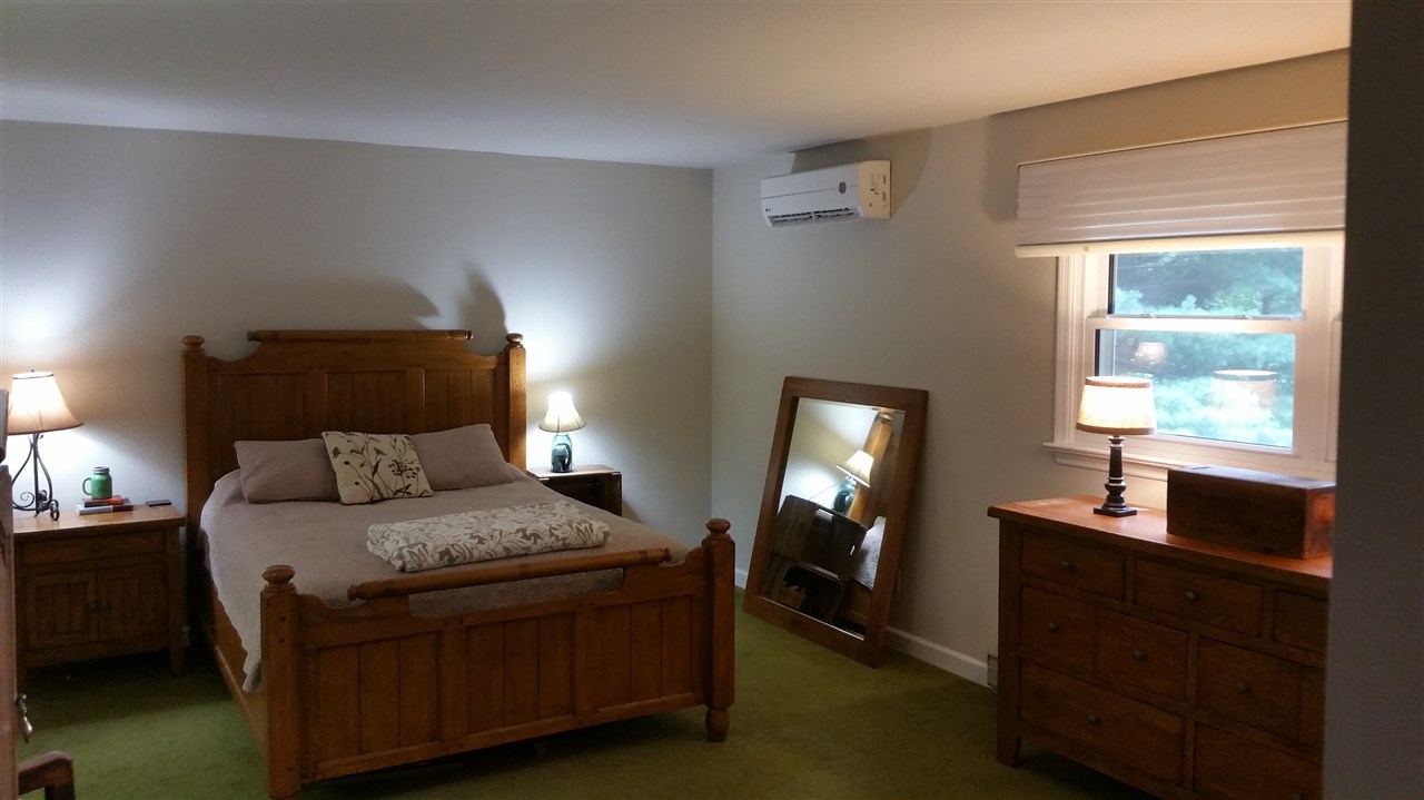 145 Free Mason Run Road Mount Solon, VA 22843 - Photo 18 of 37 a bedroom with a bed and a lamp on dresser next to a window
