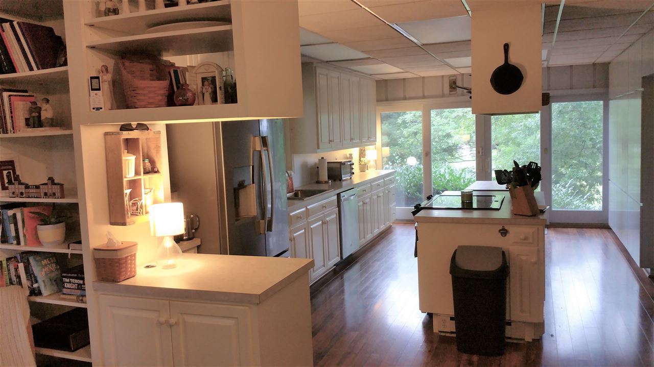 145 Free Mason Run Road Mount Solon, VA 22843 - Photo 6 of 37 a kitchen with stainless steel appliances granite countertop a refrigerator a oven a stove and a dining table with wooden floor