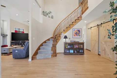 a view of entryway livingroom and hall with wooden floor