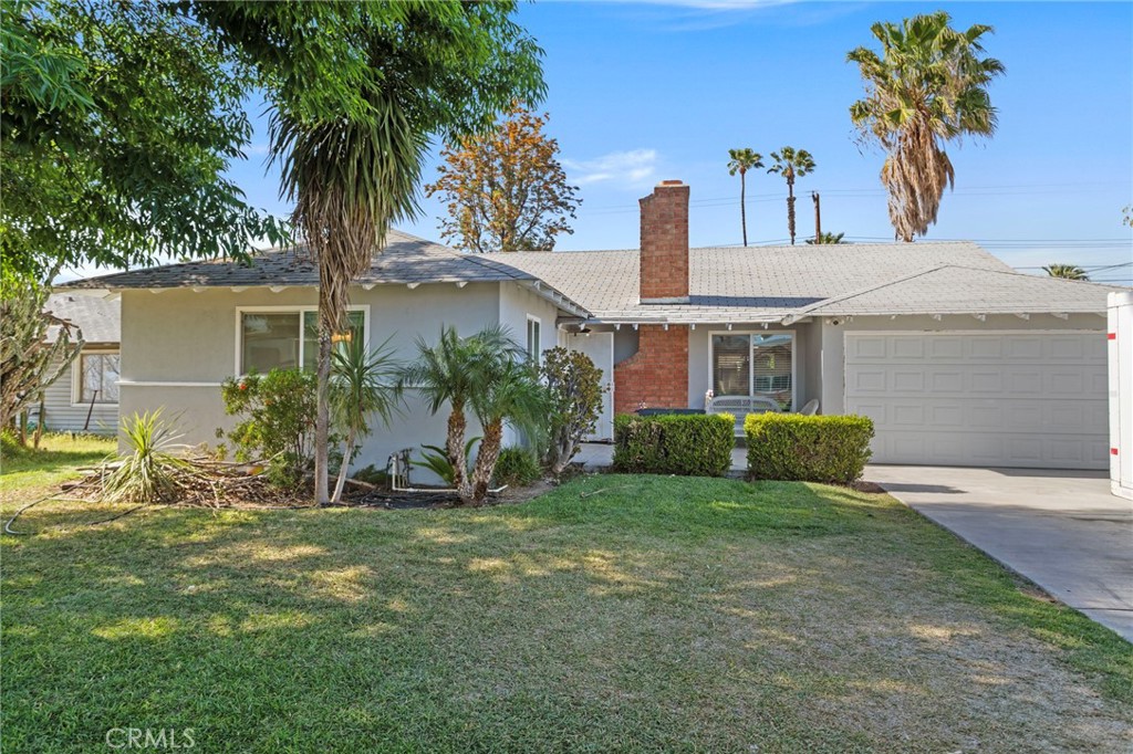10409 Cochran Avenue Riverside, CA 92505 - Photo 1 of 1 a front view of a house with a garden and tree