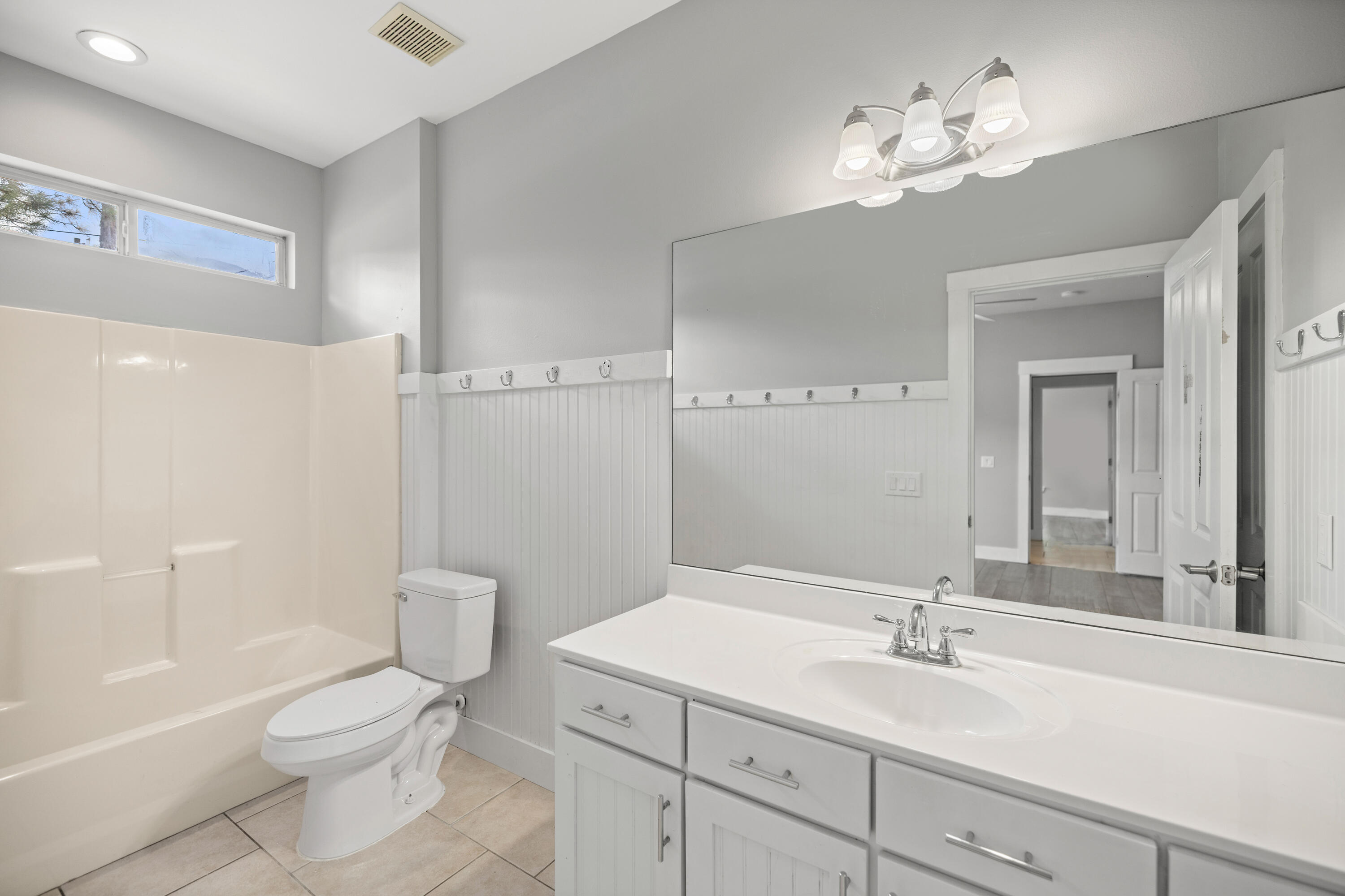 42 Pritchard Road Miramar Beach, FL 32550 - Photo 32 of 51 a bathroom with a toilet a sink a tub and a mirror