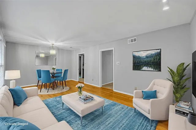 a living room with furniture a rug and a lamp