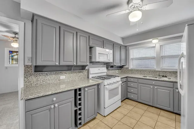 a kitchen with a sink stove and cabinets