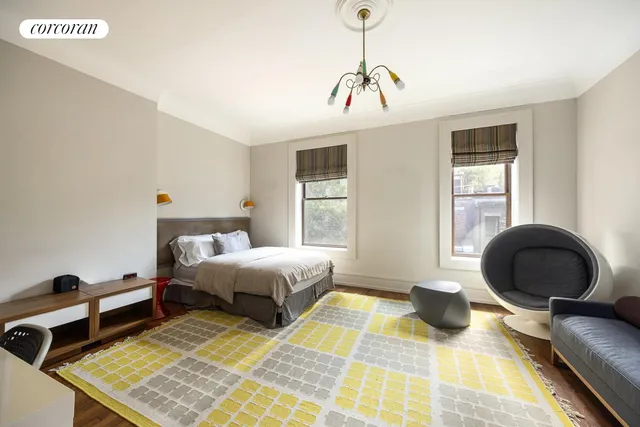 a bedroom with a bed and a fireplace