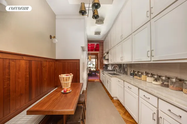 a view of a living room with a table and chairs