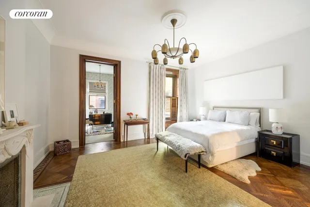 a bedroom with furniture and a large window