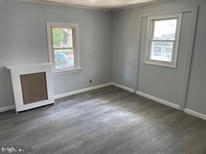 429 Jackson Avenue, Unit H Magnolia, NJ 08049 - Photo 4 of 8 an empty room with windows