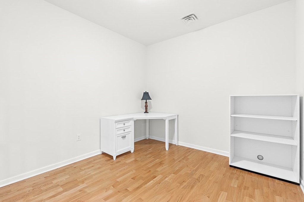 36 Abigail Way, Unit 3003 Reading, MA 01867 - Photo 11 of 42 a view of an empty room with wooden floor and a window